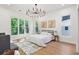 Main bedroom with large windows, hardwood floors, and a statement chandelier at 977 Fleetwood Cir, Atlanta, GA 30311