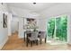 Modern dining room with hardwood floors and sliding glass doors leading to backyard at 977 Fleetwood Cir, Atlanta, GA 30311