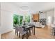 Open concept dining area with hardwood floors, adjacent to living room and kitchen at 977 Fleetwood Cir, Atlanta, GA 30311