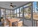 Screened porch with wooden dining set and ceiling fan at 1097 Dell Se Ave, Smyrna, GA 30080