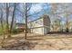 Back of house showing deck and surrounding woods at 1450 Tudor Pl, Grayson, GA 30017