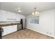 Eat-in kitchen with white cabinets and granite countertops at 1450 Tudor Pl, Grayson, GA 30017