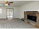 Living room with fireplace, ceiling fan, and patio access at 1450 Tudor Pl, Grayson, GA 30017