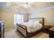 Main bedroom with a king-size bed and tray ceiling at 1653 Perserverence Hill Nw Cir # 10, Kennesaw, GA 30152