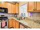 Kitchen with granite countertops and wood cabinets at 1653 Perserverence Hill Nw Cir # 10, Kennesaw, GA 30152