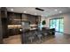 Modern kitchen with a large island, barstool seating, and stainless steel appliances at 6711 Bishop Rd, Fairburn, GA 30213