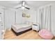 Charming bedroom with hardwood floors, ceiling fan, and pink beanbag chair at 6828 Lockridge Dr, Atlanta, GA 30360