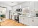 Modern kitchen with white cabinets, stainless steel appliances and light wood floors at 6828 Lockridge Dr, Atlanta, GA 30360