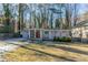 Ranch style home with a red door and covered porch at 1883 La Mesa Ln, Decatur, GA 30032