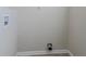 Simple laundry room with hookups and built-in shelving at 1883 La Mesa Ln, Decatur, GA 30032