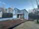 Two-story house with gray siding and brick accents, attached garage, and covered porch at 566 Abbott Se Ct, Atlanta, GA 30354