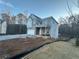 Two-story house with gray siding and brick accents, attached garage, and covered porch at 566 Abbott Se Ct, Atlanta, GA 30354