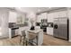 Modern kitchen with white cabinets, granite island and stainless steel appliances at 566 Abbott Se Ct, Atlanta, GA 30354