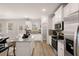 Modern kitchen with white cabinets, granite countertops, and stainless steel appliances at 566 Abbott Se Ct, Atlanta, GA 30354