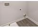 Clean laundry room with vinyl flooring and built-in shelving at 566 Abbott Se Ct, Atlanta, GA 30354