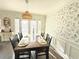 Sun-filled dining room with wooden table, chairs, and access to the living room at 6980 Roswell Rd # E1, Sandy Springs, GA 30328