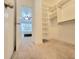 Large walk-in closet with custom built-ins and neutral carpet at 6980 Roswell Rd # E1, Sandy Springs, GA 30328