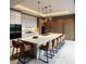 Spacious kitchen showcasing a sizable island with seating, stylish pendant lights, and built-in ovens at 7512 Rivertown Rd, Fairburn, GA 30213