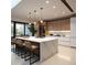 Modern kitchen featuring a large island with marble countertops, pendant lighting, and sleek cabinetry at 7512 Rivertown Rd, Fairburn, GA 30213