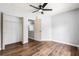 Bedroom featuring wood floors, closet, and ceiling fan at 125 Cinnamon Fern Cir, Covington, GA 30016