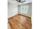 Well-lit bedroom with hardwood floors and ceiling fan at 125 Cinnamon Fern Cir, Covington, GA 30016