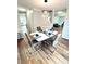 Bright dining room with modern table and chairs, hardwood floors at 125 Cinnamon Fern Cir, Covington, GA 30016