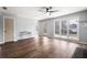 Spacious living room featuring a ceiling fan, windows, and access to other areas at 125 Cinnamon Fern Cir, Covington, GA 30016