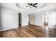 Bright main bedroom with hardwood floors, modern ceiling fan, and access to main bath and closet at 125 Cinnamon Fern Cir, Covington, GA 30016