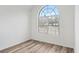 Bright bedroom featuring hardwood floors and a large arched window at 435 Berkshire Dr, Covington, GA 30016