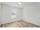 Well-lit bedroom with hardwood floors and a window with blinds at 435 Berkshire Dr, Covington, GA 30016