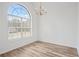 Bright dining room with hardwood floors, large window, and chandelier at 435 Berkshire Dr, Covington, GA 30016