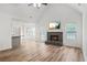 Living room with fireplace, vaulted ceiling and wood flooring at 435 Berkshire Dr, Covington, GA 30016