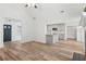 Open living room with gray kitchen island and vaulted ceiling at 435 Berkshire Dr, Covington, GA 30016