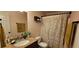 Charming bathroom with granite counters, decorative shower curtain, and decorative towel rack at 553 Stonemill Mnr, Lithonia, GA 30058