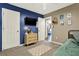 Spacious bedroom with blue and beige walls and a dresser at 300 Orchard Dr, Temple, GA 30179