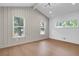 Bright bedroom with hardwood floors and gray board wall at 350 Jayne Ellen Way, Alpharetta, GA 30009