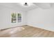 Bright bedroom with wood-look floors and a window offering natural light at 350 Jayne Ellen Way, Alpharetta, GA 30009