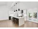 Open concept kitchen, island with seating, and access to backyard deck at 350 Jayne Ellen Way, Alpharetta, GA 30009