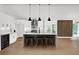 Bright kitchen features an island, breakfast bar, and wood accent wall at 350 Jayne Ellen Way, Alpharetta, GA 30009