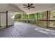 Spacious screened porch with gray wood decking and ceiling fan at 350 Jayne Ellen Way, Alpharetta, GA 30009