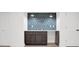 Basement wet bar with dark cabinetry and blue tile backsplash at 350 Jayne Ellen Way, Alpharetta, GA 30009