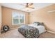 Bright bedroom with large window, ceiling fan, and floral bedding at 604 Arbor Rdg, Loganville, GA 30052