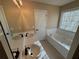 Bathroom with double sinks, a bathtub, and neutral colors at 1563 Nicole Ridge Ct, Loganville, GA 30052