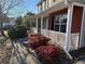 House's side entrance with a covered porch and red brick accents at 1563 Nicole Ridge Ct, Loganville, GA 30052