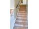 Carpeted staircase with white railing at 1563 Nicole Ridge Ct, Loganville, GA 30052