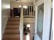 Staircase leading to the upper level, with a view of the living area at 390 Lakeridge Ct, Riverdale, GA 30274