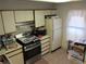 A galley kitchen with a refrigerator, oven, and stovetop at 390 Lakeridge Ct, Riverdale, GA 30274