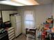 A cluttered kitchen with white cabinets and appliances at 390 Lakeridge Ct, Riverdale, GA 30274