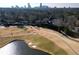 Aerial view of golf course with pond and cityscape in background at 4002 Club Ne Dr, Atlanta, GA 30319