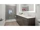 Modern bathroom with double vanity, walk-in shower, and gray tile at 775 Juniper Ne St # 413, Atlanta, GA 30308